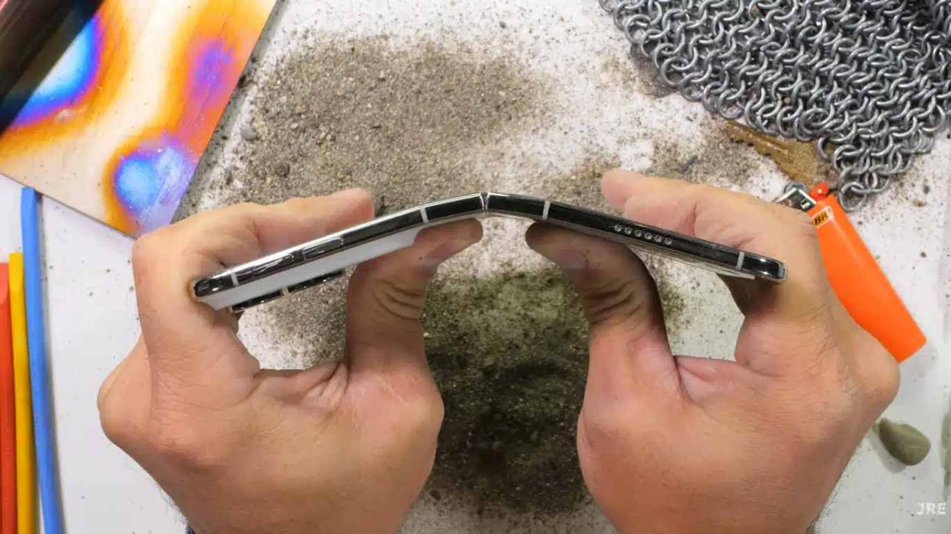 Apple iPhone Duo foldable smartphone undergoing a durability test that damaged its hinge and inner display.
